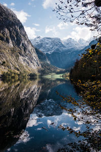 Scenic view of lake and snowcapped mountains against sky