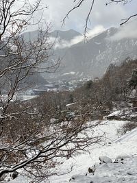 Scenic view of snow covered mountains against sky