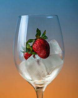 Close-up of strawberries on glass against white background