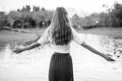 Rear view of woman standing in water