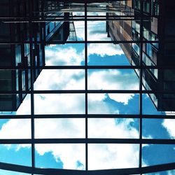 Low angle view of modern building against blue sky