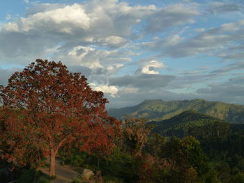 Scenic view of mountains against cloudy sky