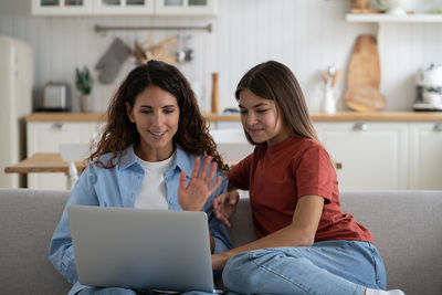 Young woman using laptop at home