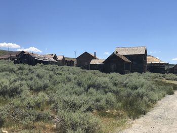 Houses on field against clear sky