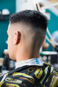 Male customer with hairstyle sitting at salon