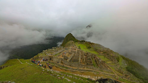 Aerial view of mountain against cloudy sky