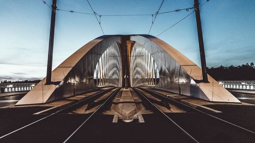 Suspension bridge against sky in city