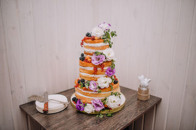 Close-up of cake on table against wall