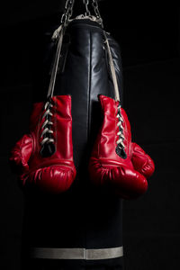 Close-up of shoes hanging against black background