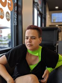 Portrait of woman sitting on chair in cafe