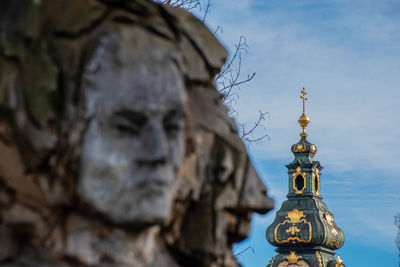 Statue of temple against building