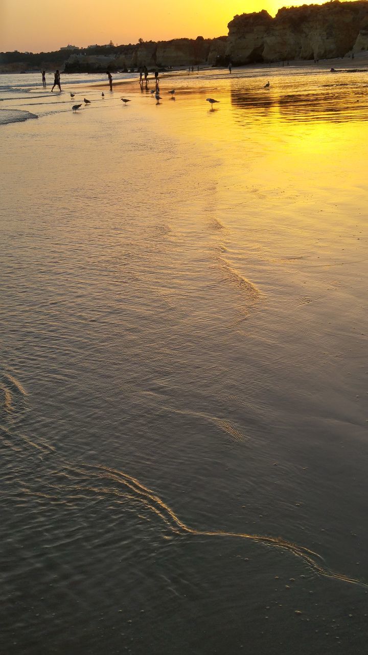 water, beach, sea, sunset, reflection, nature, scenics, outdoors, sand, beauty in nature, wave, coastline, tranquil scene, rippled, tranquility, vacations, no people, sky, refraction, day