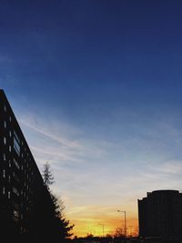 Low angle view of silhouette trees against sky during sunset