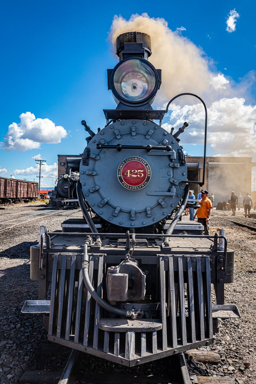 train, sky, transportation, vehicle, cloud, rail transportation, transport, locomotive, mode of transportation, nature, architecture, steam engine, steam train, no people, day, land vehicle, blue, outdoors, railroad track, track, city, public transportation, the past, history