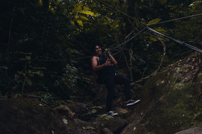 Woman zip lining in forest