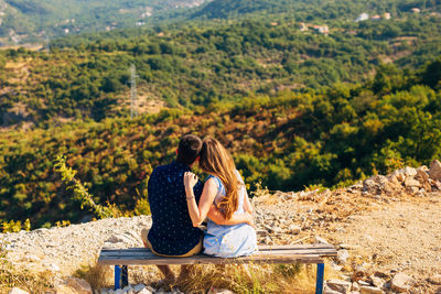 Rear view of woman sitting at park