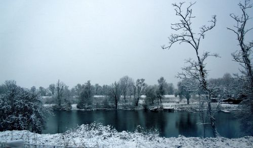 Scenic view of lake against sky during winter