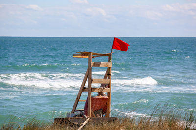 Lifeguard hut on beach against sky