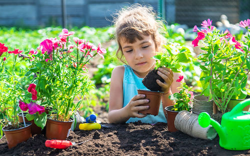 Portrait of cute girl picking flowers