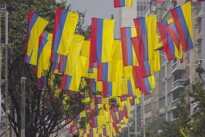 Low angle view of multi colored flags hanging on building