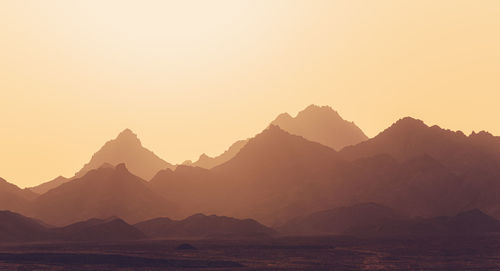 Panoramic view of mountains against clear sky during sunset