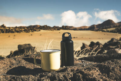 Kinds of comfort after day of trekking on paths near volcano. yellow sand blue sky in background.