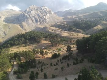 Scenic view of landscape and mountains against sky