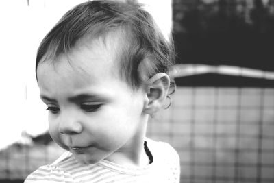 Close-up portrait of cute girl looking away