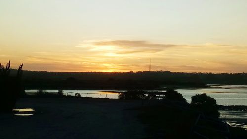 Scenic view of lake against sky during sunset