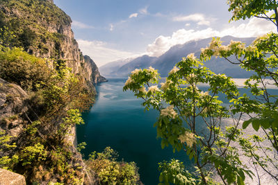 Scenic view of sea and mountains against sky