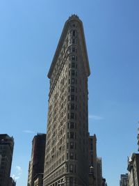 Low angle view of buildings against blue sky
