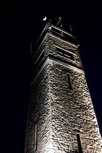 Low angle view of illuminated building against sky at night