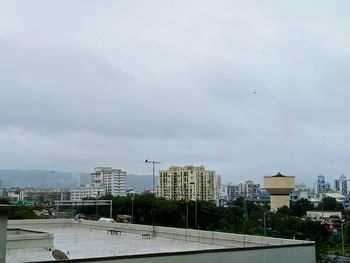 City street and buildings against sky