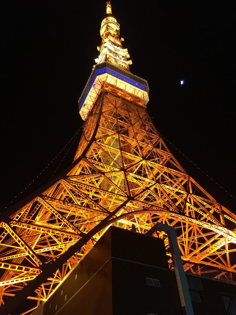 LOW ANGLE VIEW OF ILLUMINATED BUILDING AGAINST SKY