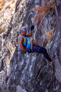 Side view of man rock climbing