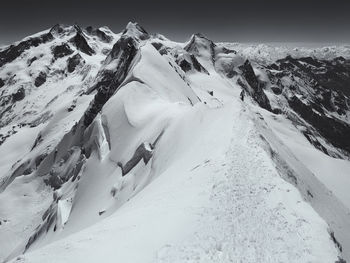 Snow covered mountains against sky