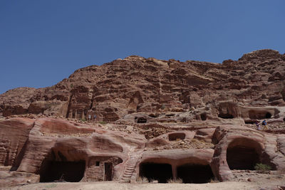 Low angle view of old ruins against clear blue sky