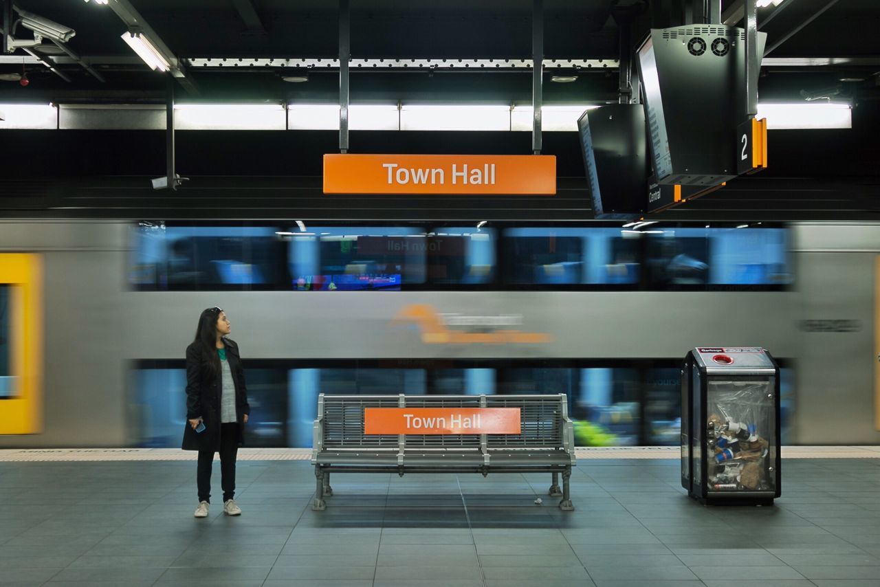 transportation, public transportation, mode of transport, blurred motion, railroad station, travel, motion, rail transportation, train - vehicle, casual clothing, lifestyles, journey, railroad station platform, illuminated, person, subway station, passenger, information sign, commuter, city life