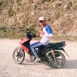 Side view of man riding motorcycle