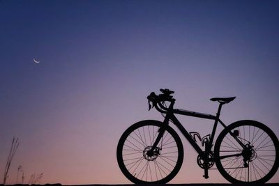 Bicycle against clear sky at night