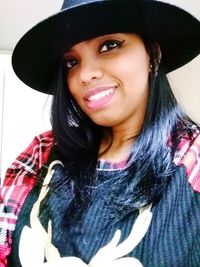 Portrait of a smiling young woman in hat
