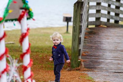 Full length of boy standing on shore