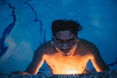 Portrait of young man in swimming pool