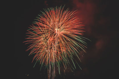 Low angle view of firework display at night