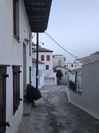 Street amidst buildings in town against clear sky