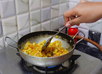 Midsection of person preparing food in kitchen