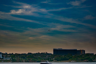 View of buildings in city against sky during sunset