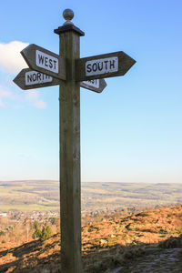 Information sign on landscape against clear sky