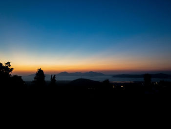 Scenic view of silhouette mountains against sky at sunset