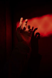 Close-up of people hand with red light